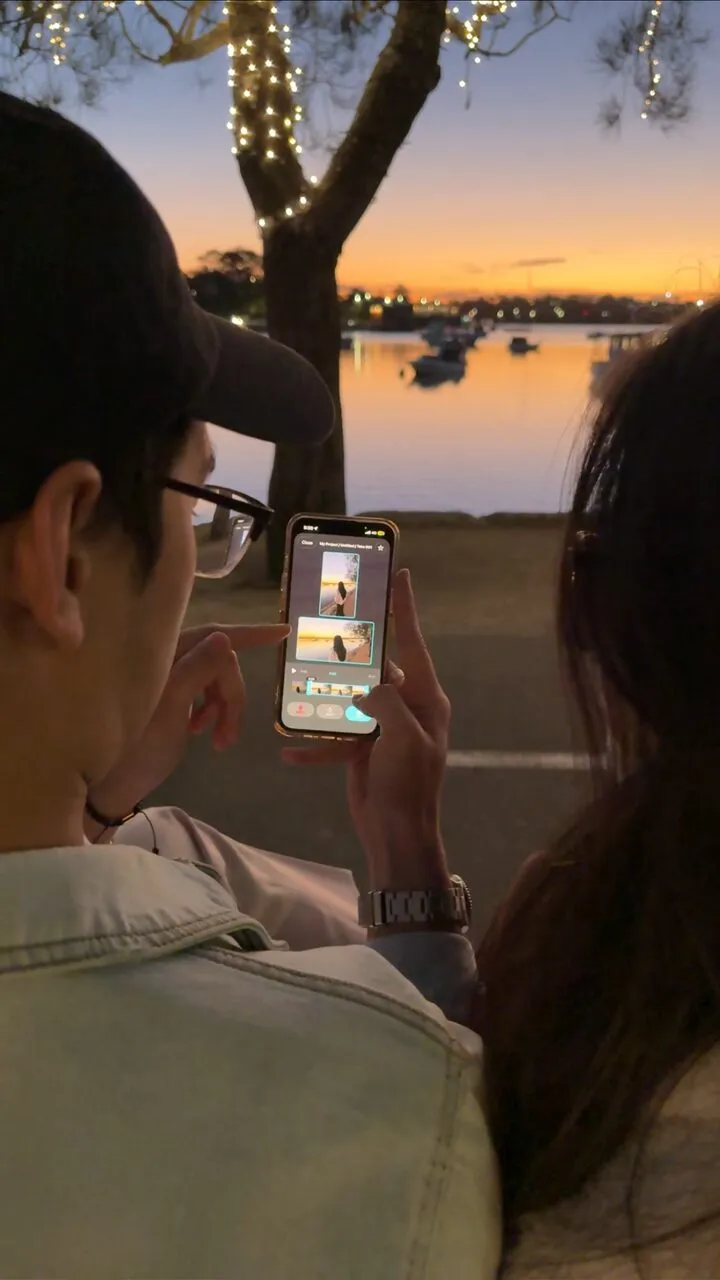 Two creators filming a Sydney harbour sunset in portrait and landscape at once